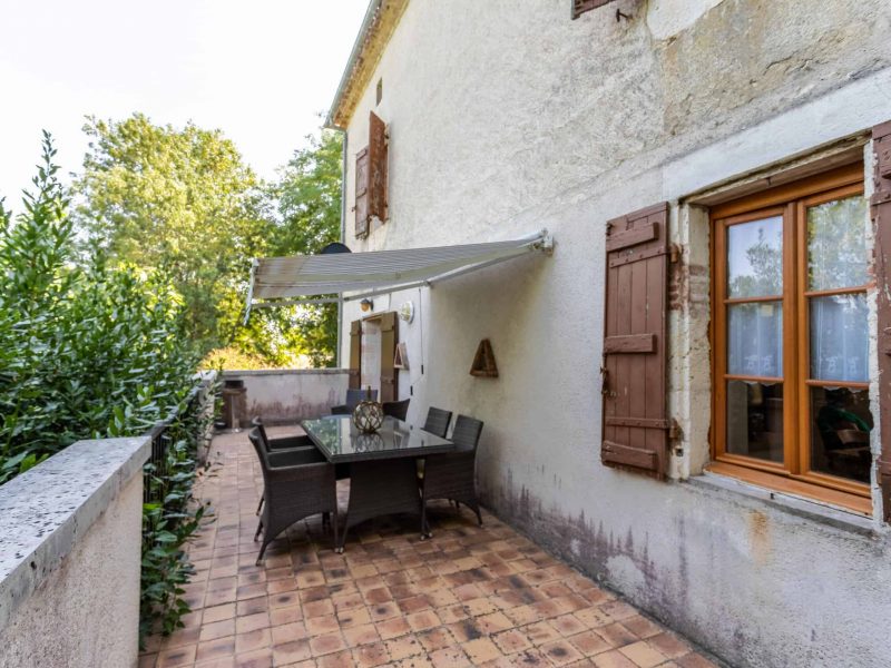 Charming outdoor terrace of a French countryside property, ideal for relaxing and al fresco dining in Southwest France.